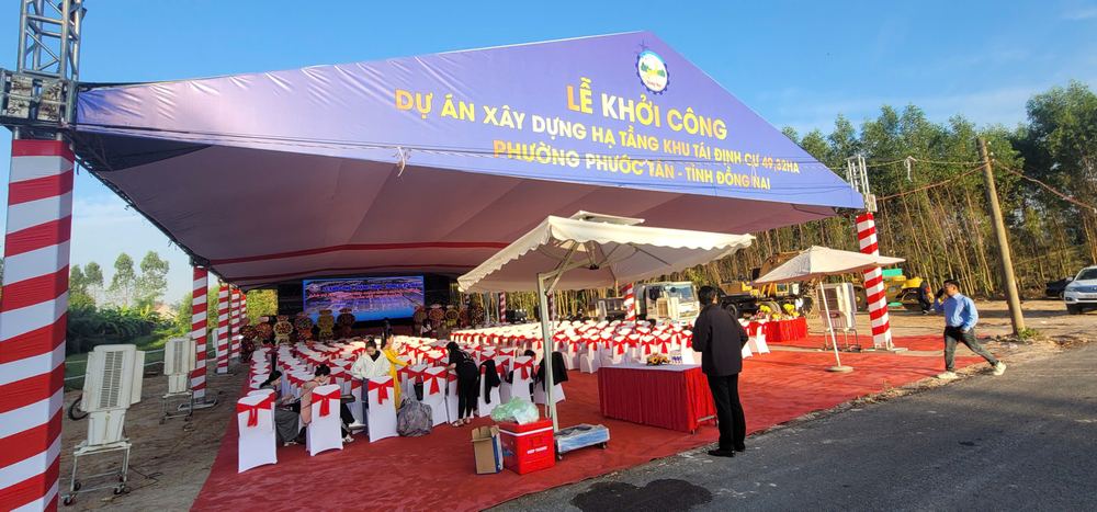 Nhà bạt lễ khởi công dự án với băng rôn xanh và khu vực đại biểu